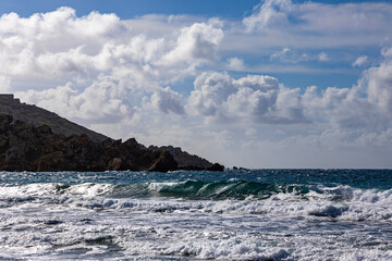 Golden Bay, Malta. Rocks with large waves in the Mediterranean Sea.