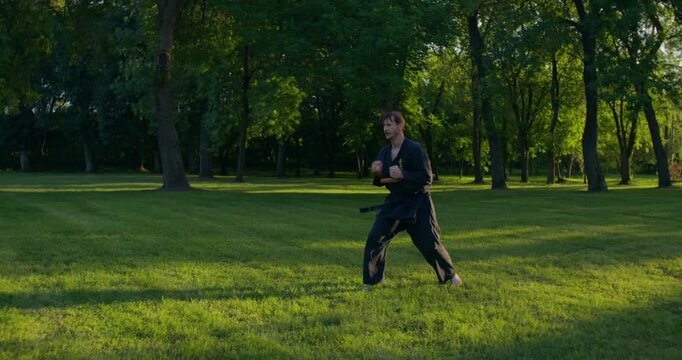 Male karateka trains to use tonfu weapons. .