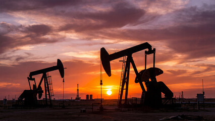 silhouette of oil pump at sunset