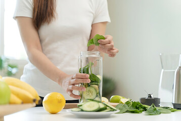 Woman Preparing Fresh Fruit Smoothie Ingredients.