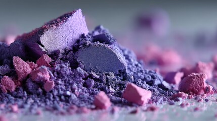 Brightly colored cosmetic powder pieces pile up in a close up shot