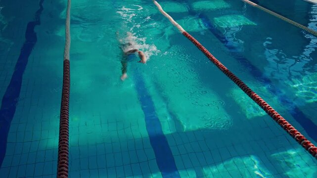 man swimming in pool. a swimming athlete trains in the pool, swims under the supervision of a coach.