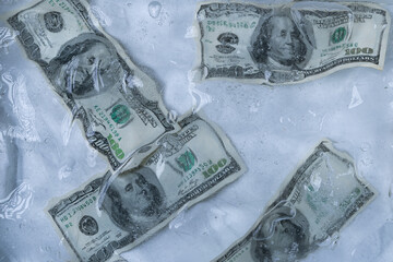 Multiple One Hundred Dollar Bills in Ice