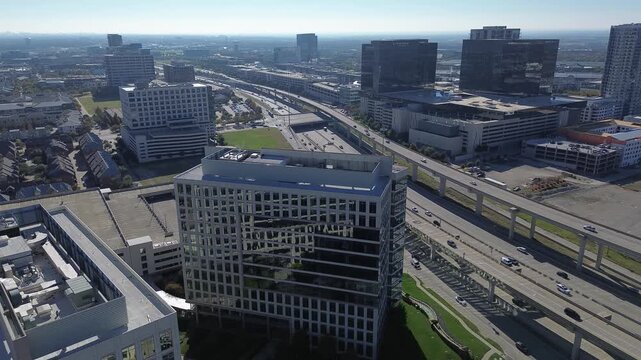 Plano central highway cuts through glass-clad office towers, residential blocks, Liberty Mutual corporate office, well-integrated urban grid and transportation backbone