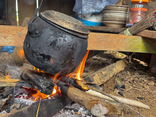 Traditional cooking with a black cauldron over an open flame