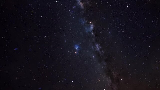 Stars shine in the night sky showcasing the beauty of the Milky Way and distant galaxies above a quiet landscape