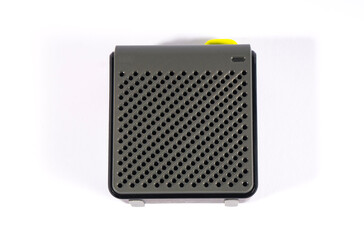 Wireless music speaker isolated on white. A modern grey audio gadget with yellow details, perfect for technology and entertainment concepts.