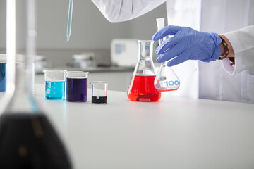 A doctor conducting research with plastic medical tubes in a modern laboratory.