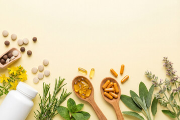 Herbal supplements and vitamins on wooden spoons with fresh herbs