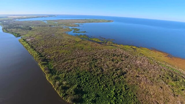 Aerial view of the winding Lake Okeechobee coastline showcases the contrast between the dark waters and the lush vegetation, Lake Okeechobee, Florida, United States.