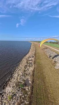 Aerial view of the contrasting dark water and green grassy land near the Lake Okeechobee coastline, Lake Okeechobee, Florida, United States.