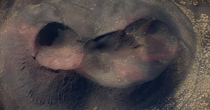 Aerial perpendicular view of the crater of Mount Etna in Sicily, Southern Italy. It is the highest active volcano in Europe. It is a beautiful summer day. Close-up from above of a volcanic crater.