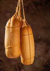 Provolone cheese, wonderful smoked provolone cheese, abstract background, selective focus.