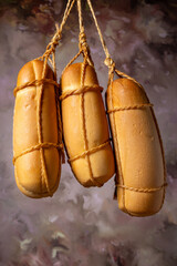 Provolone cheese, wonderful smoked provolone cheese, abstract background, selective focus.