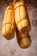 Provolone cheese, wonderful smoked provolone cheese, abstract background, selective focus.