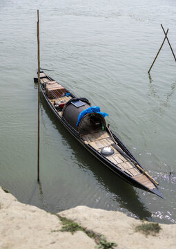 Bangladeshi woman embarking on a fishing boat, Dhaka Division, Shivalaya, Bangladesh