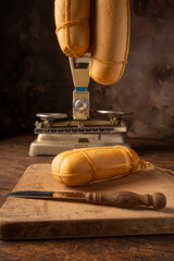 Provolone cheese, wonderful smoked provolone cheese on rustic wood and accessories, abstract background, selective focus.