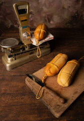 Provolone cheese, wonderful smoked provolone cheese on rustic wood and accessories, abstract background, selective focus.