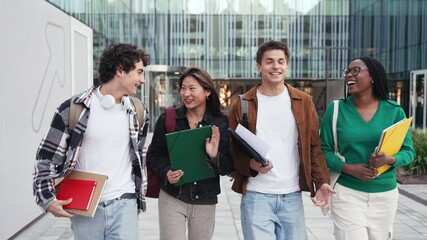 College student friends talking and walking out of University school campus 
