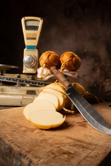 Provolone cheese, wonderful smoked provolone cheese on rustic wood and accessories, abstract background, selective focus.