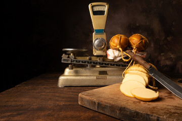 Provolone cheese, wonderful smoked provolone cheese on rustic wood and accessories, abstract background, selective focus.