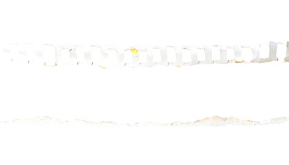 A torn strip with evenly spaced holes and irregular edges, isolated against a black backdrop