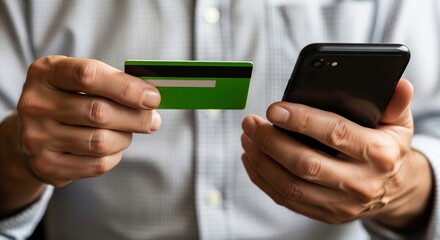 Person holding credit card and smartphone making secure digital payment online