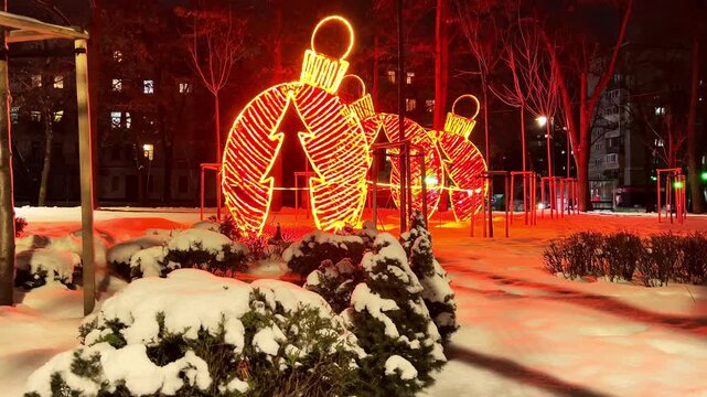 The bright Christmas ornament installation in the snowy park