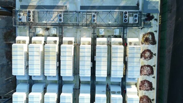 Birmingham, United Kingdom - 31 December 2025: Aerial view of the ATOS long bridge Data Centre shows rows of white server units and cooling systems on a rooftop.