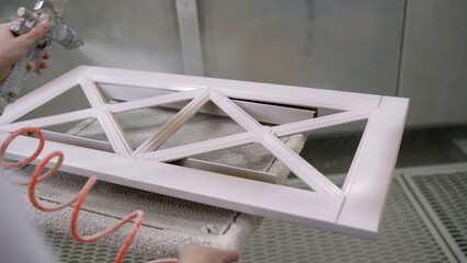 Automated spray painting robot arm applying white paint