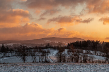 Winter snowy cold sunrise near Roprachtice village in Krkonose mountains