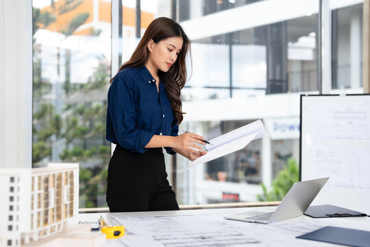 professional architects, engineers working on new construction project of building .