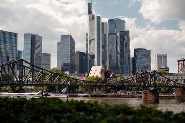 Frankfurt skyline with historic bridge and modern skyscrapers on a cloudy day