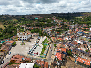 Historic town square in Brazil with colonial church and surrounding urban landscape