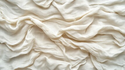 Wrinkled cream colored fabric texture, likely linen or silk, background shot for fashion or home decor