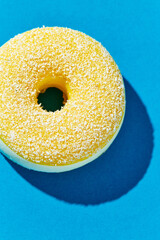 Overhead view of Delicious donut on colored background