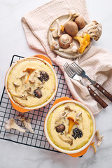 Quiche with chanterelle mushrooms, oyster mushrooms, button mushrooms, and cheese in two serving dishes