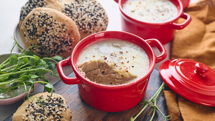 Gourmet Liver Pate Appetizer with Sesame Seed Bagels and and Fresh Pea Shoots on Rustic Wooden Board