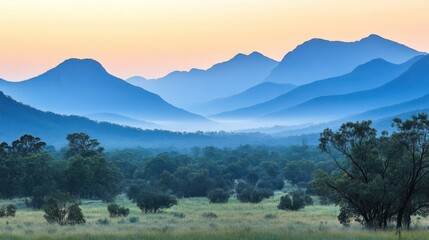 Misty mountain range at dawn. Peaceful valley landscape.  Possible use Nature photography