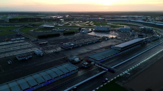 Towcester, United Kingdom - 20 December 2025: Aerial view of the expansive Silverstone race track, its stark gray tarmac contrasting with the surrounding green landscape.