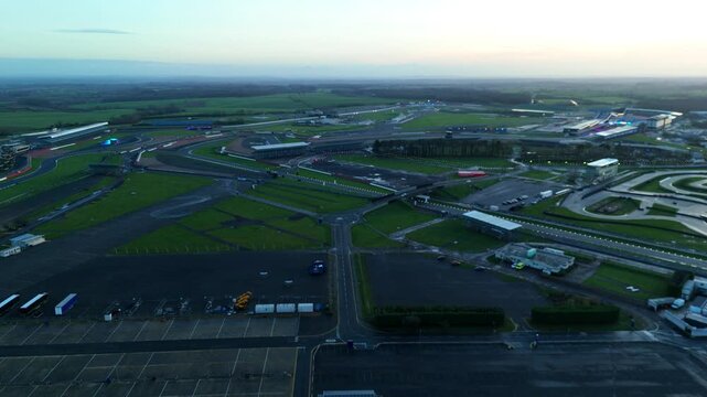 Towcester, United Kingdom - 20 December 2025: Aerial view of the Silverstone Circuit where the grey track cuts through the green landscape.