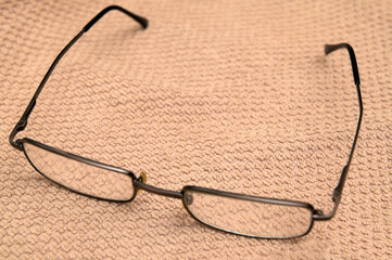 Old glasses lying on a piece of fabric
