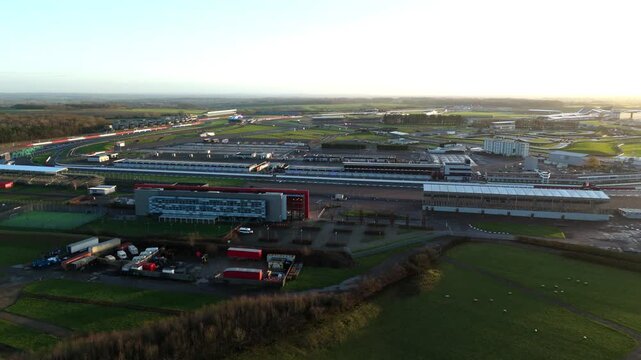 Towcester, United Kingdom - 20 December 2025: Aerial view of the Silverstone Circuit, a racetrack surrounded by lush greenery and a vast complex of buildings.