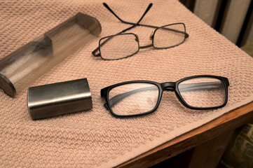 Old glasses lying on a piece of fabric