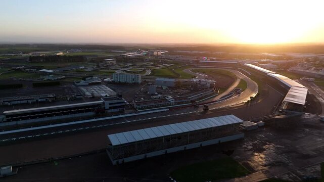 Towcester, United Kingdom - 20 December 2025: Aerial view of the Silverstone Circuit track glistening under the morning sun, showcasing its vast expanse and turns.
