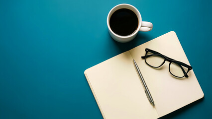 Overhead view of essential office supplies including a fresh cup of black coffee, open notebook, silver pen, and modern reading glasses resting on a vibrant teal desk surface.