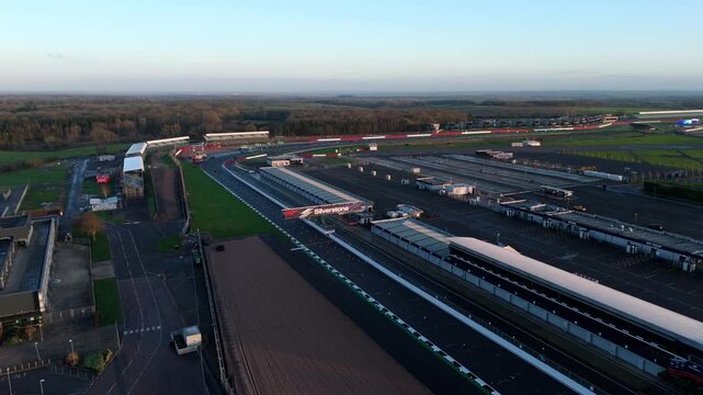 Towcester, United Kingdom - 20 December 2025: Aerial view of the Silverstone Circuit, with its racing track and buildings, bathed in soft, early morning light.