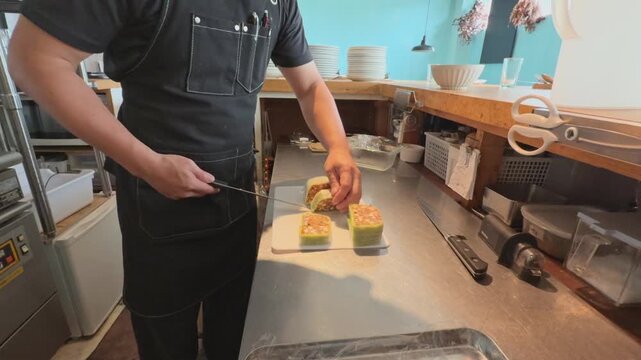 A chef slicing an octopus and gazpacho terrine 