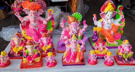 decorated ganesh murti with vibrant ornaments at local market stall