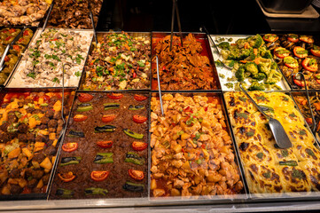 Assortment of traditional Turkish dishes in metal trays at a local self-service restaurant